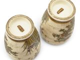pair of asian vases on a white background with a gold border