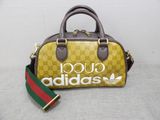 guccissi handbag with a green and red stripe strap