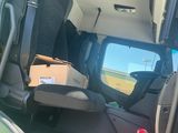 a green van with a box in the back of it