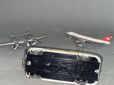 a toy airplane and a model airplane on the floor