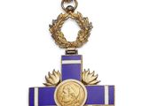 a close up of a cross with a medal on it