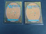 two decks of magic the gathering deck cards on a table
