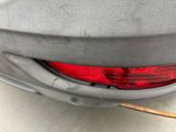 a close up of a car ' s rear end with a red light