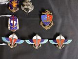 several different badges are displayed on a black surface