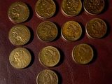 several different types of coins are arranged in a circle on a table