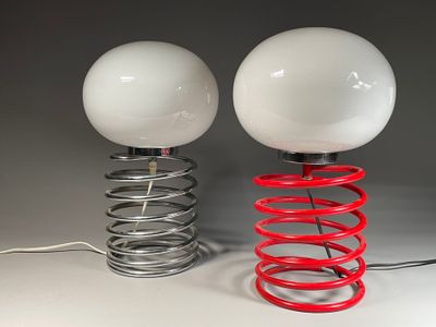 two lamps that are on top of a red spring