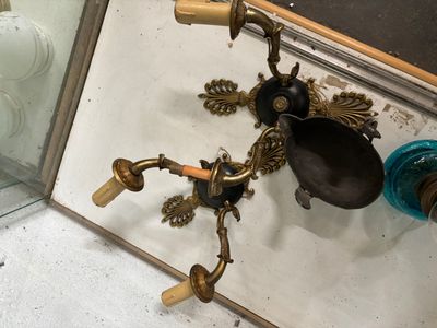 a mirror with a brass faucet on it and a blue vase
