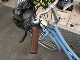a blue bicycle with a helmet on it in a shop