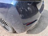 a close up of a car ' s rear end with scratches on it