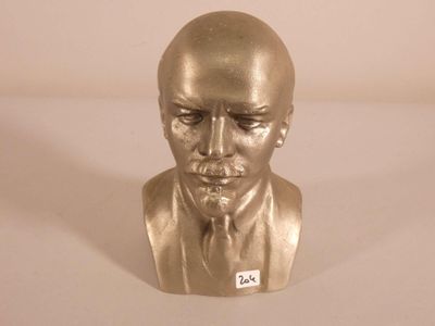 a gold bust of a man with a tie on