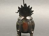 silver statue of a horse with horns and horns on its back
