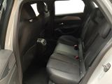 the back seats of a car with the door open and the driver ' s seat down