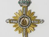 a close up of a cross with a crown on top of it