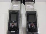 two black cell phones in the packaging on the table