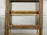 an old picture frame hanging on a wall next to a white wall