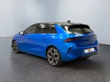 the rear end of a blue car in a white room