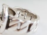 a silver ring with a horse on it sitting on a table