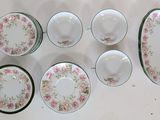 six plates and six bowls on a white table