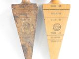 pair of vintage wooden spoons with labels on them on a white surface