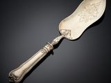 a silver spoon with a handle on a black surface