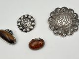 three silver and wood brooches, including a brooche, a brooche, and a brooche