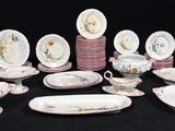 a lot of plates and bowls that are on a table