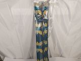 a close up of a blue and yellow umbrella on a white surface