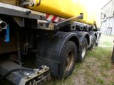 a large truck with a yellow tank on the back of it
