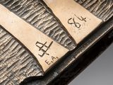 a close up of a piece of metal with some writing on it
