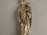 silver statue of a woman holding a child on a white surface
