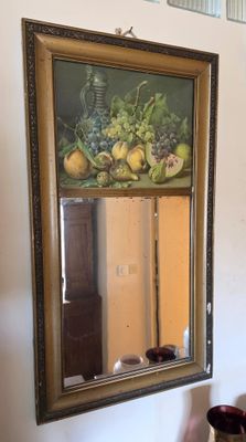 a picture of a painting hanging on the wall above a mirror