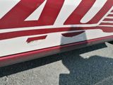 a close up of a red and white truck with a red and white stripe