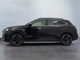 the black suv is parked in a room with a white wall