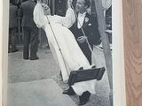 a black and white photo of a man and woman on a swing