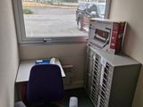 un bureau avec un ordinateur et une imprimante dans un coin