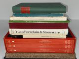 several books stacked on top of each other on a table