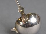 a silver object with a spoon sticking out of it
