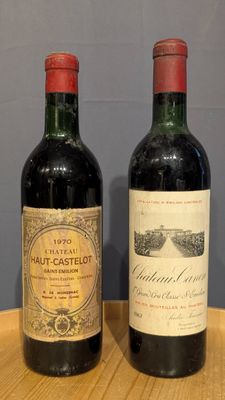 two bottles of wine sitting on top of a wooden table next to each other