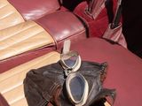 a pair of sunglasses and a pair of gloves on the seat of a car