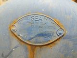 a blue fire hydrant with a metal plaque on it