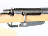 an old rifle with a wooden barrel and a metal handle