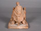 statue of a man sitting on a bench with two dogs