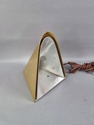 une lampe en métal en forme de triangle, munie d'un cordon