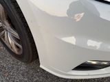 a close up of a car ' s front bumper with scratches on it