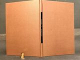 an open cardboard box with a piece of paper sticking out of it