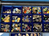 many different types of jewelry in a blue case