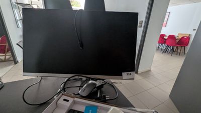 un écran d'ordinateur posé sur une table dans une pièce