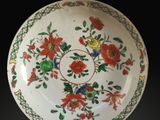 an image of a white bowl with red and green flowers on it