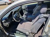the interior of a car with the door open and the passenger seat down