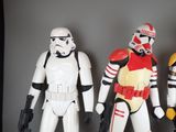 three star wars action figures are lined up against a gray background